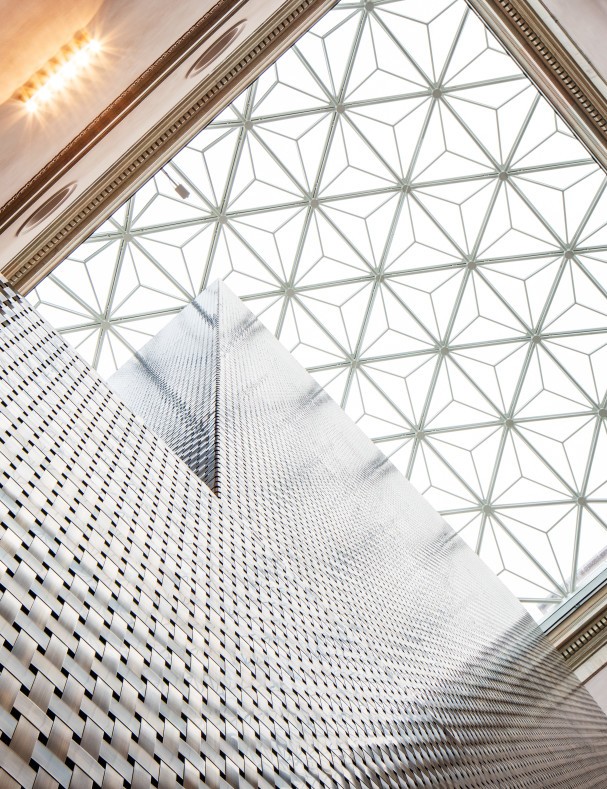 National Museum's new glass roof and elevator tower in oxidized brass.